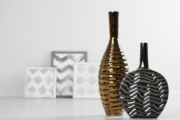 Modern vases on floor in room