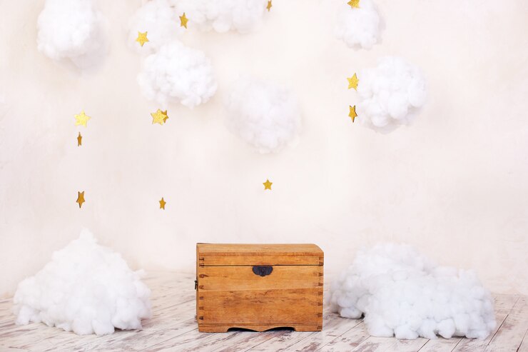 Modern vintage interior of children's room with an old wooden chest on background of a textured wall with clouds. Children's playground interior. Chest for toys and games for children. Kids room decor