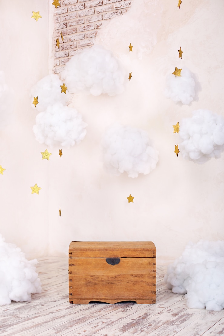 Modern vintage interior of children's room with an old wooden chest on a textured wall with clouds. Children's playground interior. Chest for toys and games for children. Kids room decor