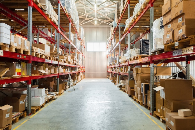 Modern warehouse shelves with pile of cardboard boxes