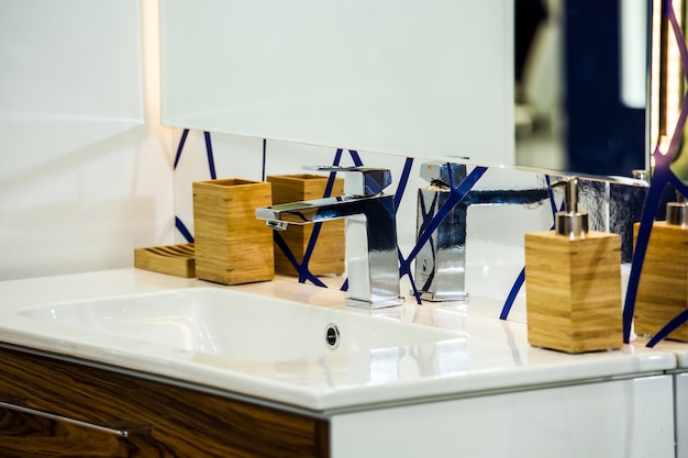 Modern washbasin with mixer tap in bathroom