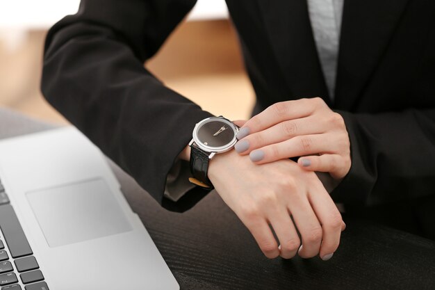 Modern watch on a businesswoman's wrist, close up