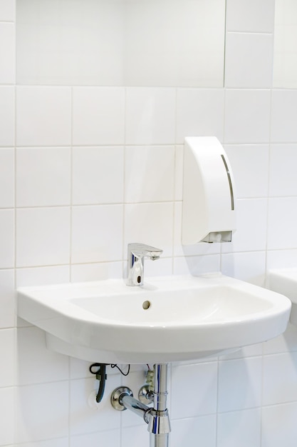 Modern white bathroom sink with faucet