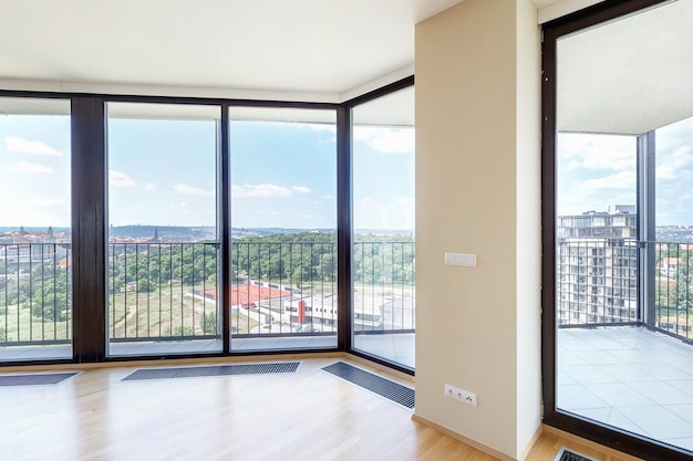 Modern white empty loft apartment interior with parquet floor and panoramic windows Overlooking the metropolis city