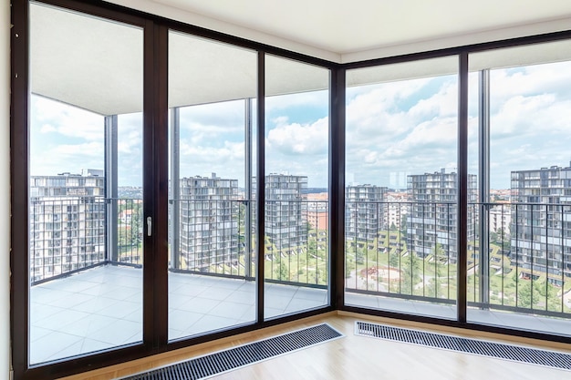 Modern white empty loft apartment interior with parquet floor and panoramic windows Overlooking the metropolis city