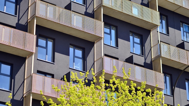 Modern white facade of a residential building with large windows