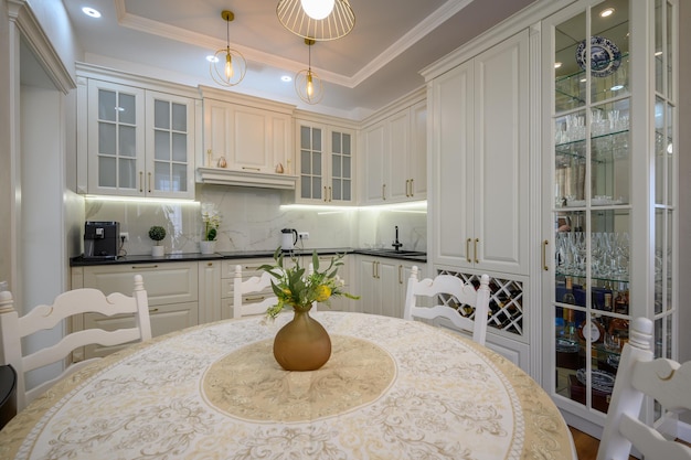 Modern white large luxurious kitchen and dining room in studio apartment