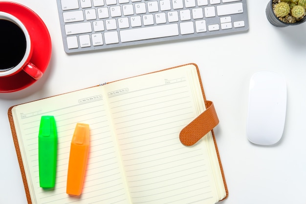 Modern white office desk with keyboard mouse notebook