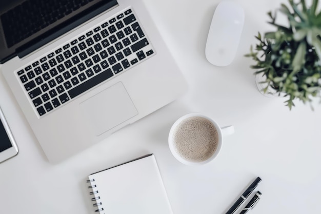 modern white office desk workstation with laptop and coffee viewed from above
