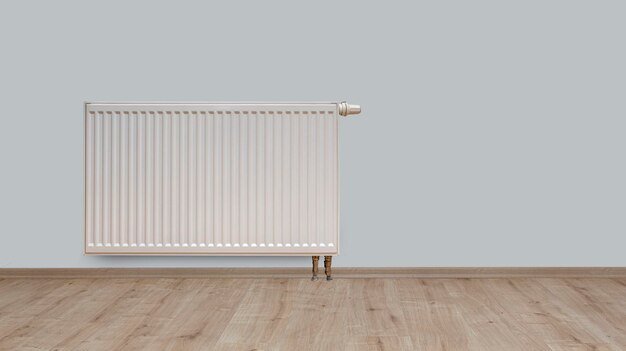 Modern white radiator on parquet floor