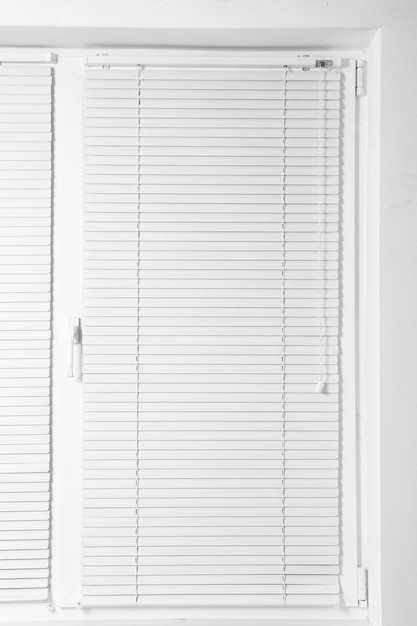 modern window with closed stylish white blinds