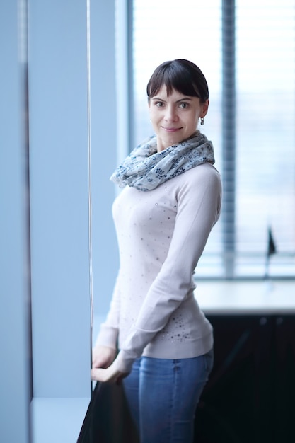 Modern woman standing in the corridor of the office.