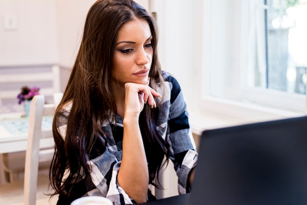 Modern woman websurfing in cafe