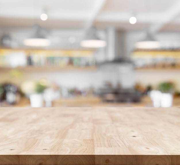 Photo modern wooden board empty table in front of blurred kitchen background .perspective table top used for display or montage your products