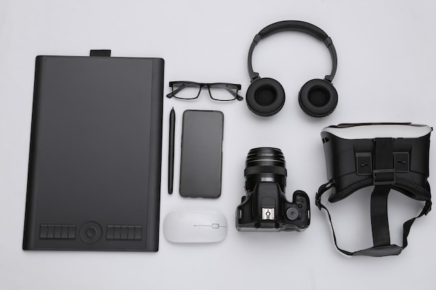 Modern work and entertainment gadgets on white background. Top view. Flat lay