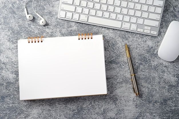 Modern Work Environment at white Office Desk with Computer Notepad pencil Green leaf