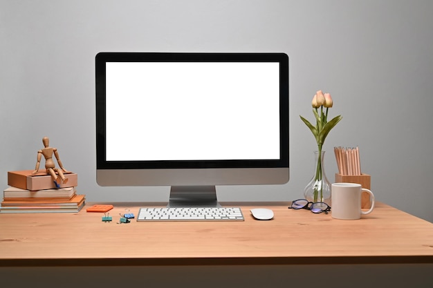 Modern workplace with computer and personal equipment on wooden desk