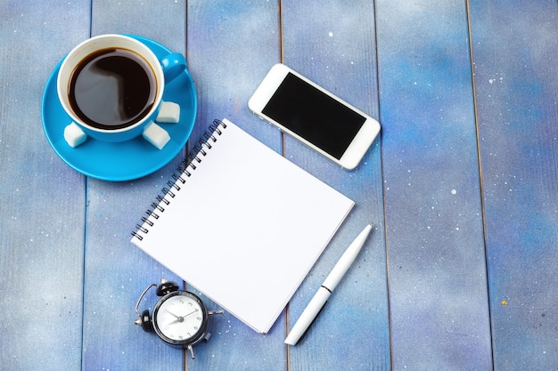 Modern workplace with cup of coffee on wooden table