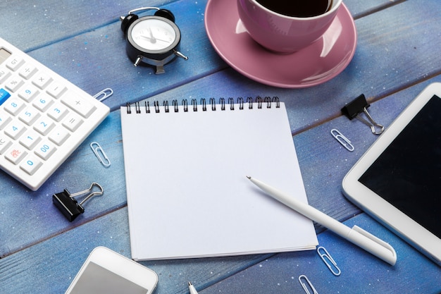 Modern workplace with cup of coffee on wooden table