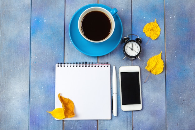 Modern workplace with cup of coffee on wooden table