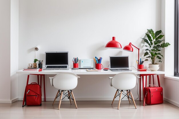 Modern workplace with two laptops on red table against white wall