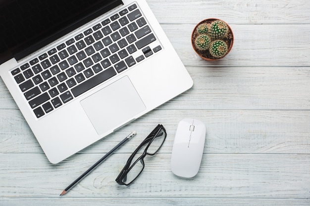 Modern workplace on wooden table with a lot of things on it