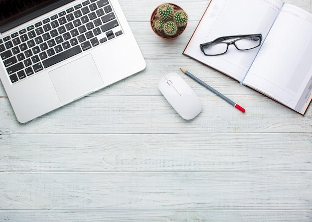 Modern workplace on wooden table with a lot of things on it