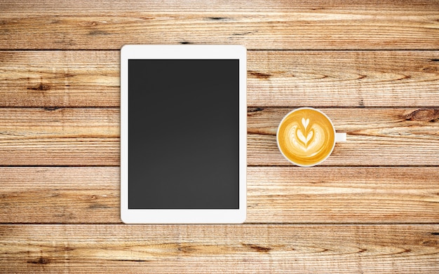 Photo modern workspace with coffee cup and tablet or smartphone on wood