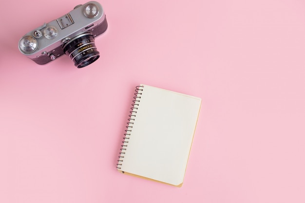 Modern workspace with photo camera and notebook