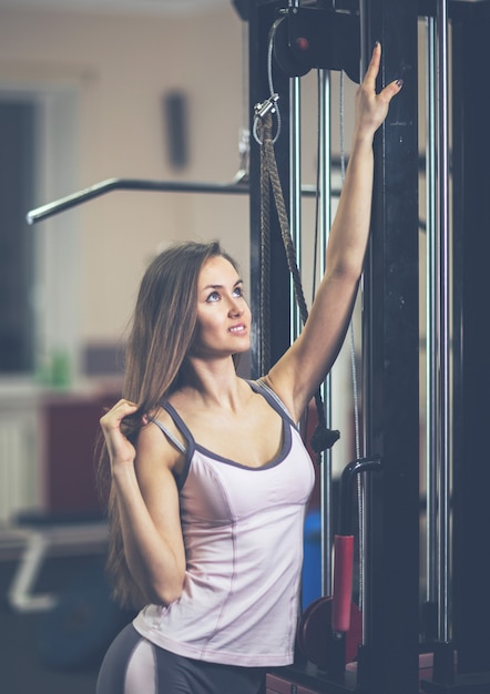 Modern young business woman exercising on a fitness machine in a fitness class at the fitness center