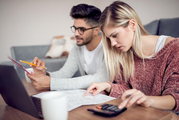 Modern young couple paying bills online