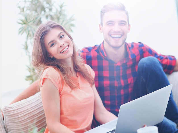 Modern young people using laptop at home