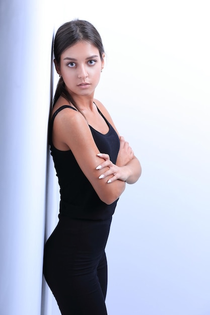 Modern young woman leaning on wall