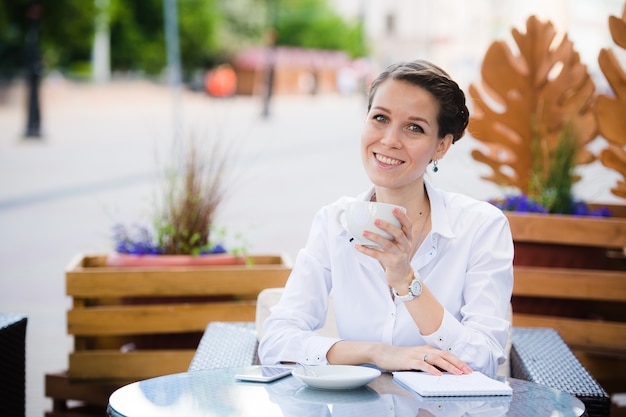 カフェに座っている現代の若い女性