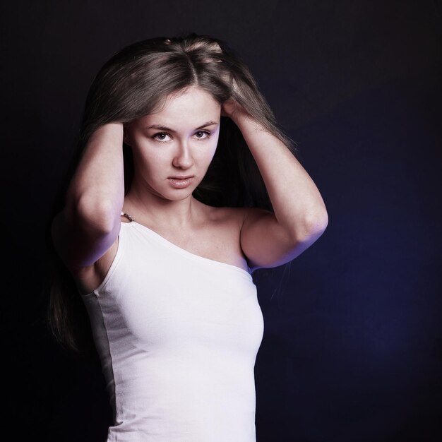 Modern young woman with long hair posing for the camera