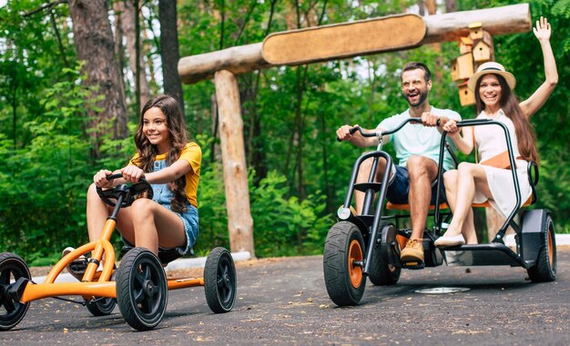 Moderne gelukkige jonge toeristische familie op vakantie rijden op fietsen en samen plezier hebben