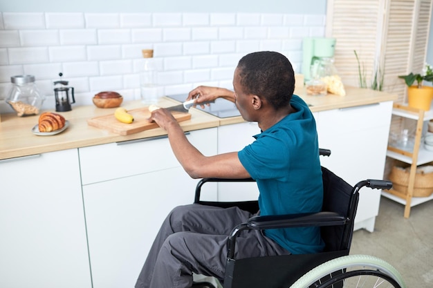 Moderne man met een handicap koken in de keuken