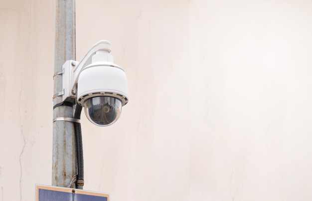 Foto moderne openbare cctv-camera op paal met onscherpte gebouw achtergrond