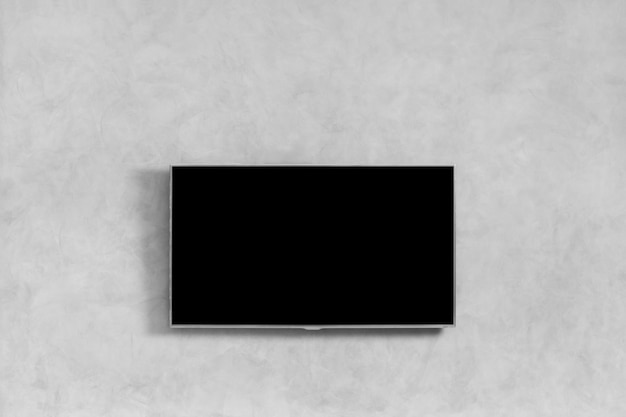 Foto moderne slimme tv met chroom frame op een grijze gestructureerde muur met ruimte voor tekst led-tv en wandlampen op de muur in het appartement