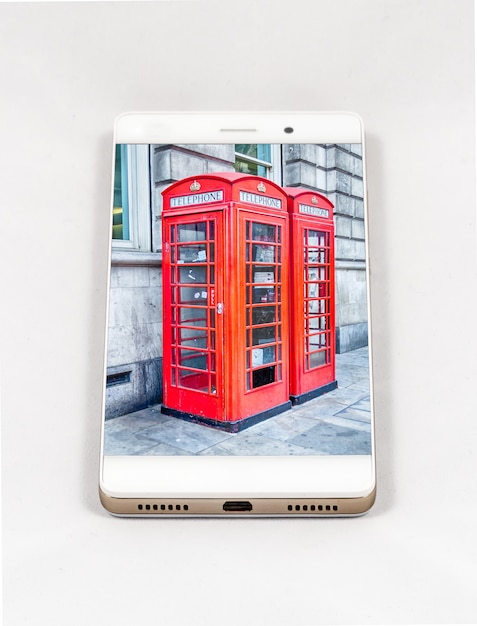 Moderne smartphone met afbeelding op volledig scherm van een iconische traditionele Britse rode telefooncel in Londen, VK