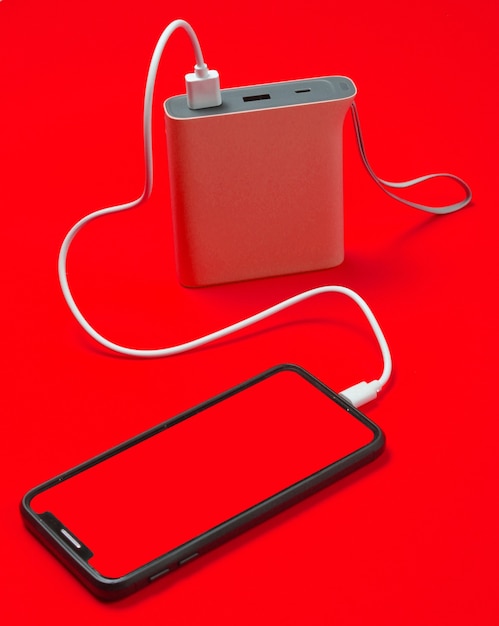 Moderne smartphone opladen met powerbank geïsoleerd