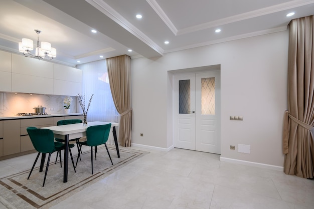 Moderne witte en beige grote luxe keuken en eettafel in studio appartement