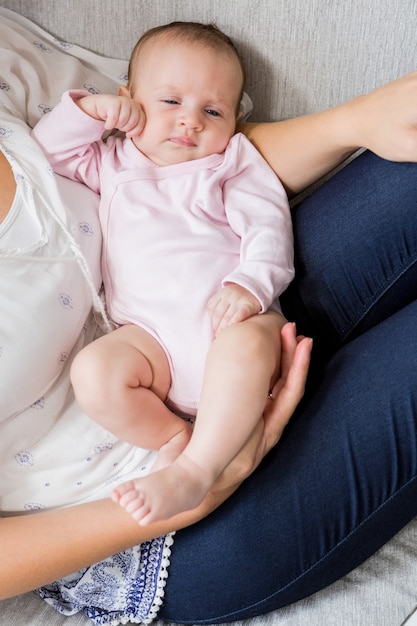 Moeder die haar baby in woonkamer vervoert