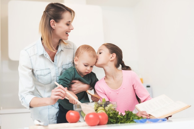 Moeder en dochter hebben plezier tijdens het bereiden van een salade.