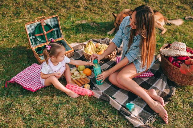 moeder en dochter op een picknick met een hond