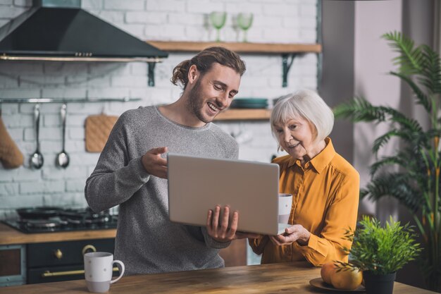 Moeder en haar zoon die op laptop kijken