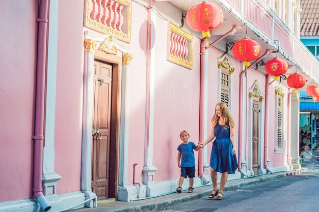 Moeder en zoon zijn toeristen op straat in de portugese stijl romani in phuket stad ook wel genoemd