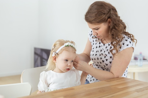 Moeder helpt bij het plaatsen van een cochleair implantaat voor haar dove dochtertje hoortoestel en doofheid