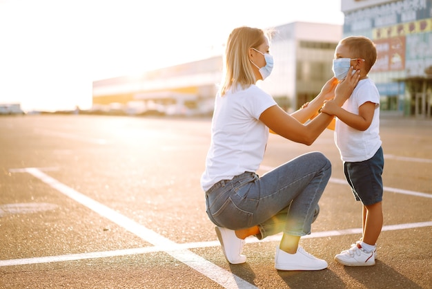 Moeder zet haar medische babymasker op bij zonsondergang.