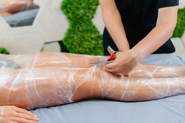 Moisture and sweat after a cosmetology wrap of a young girl in a beauty salon